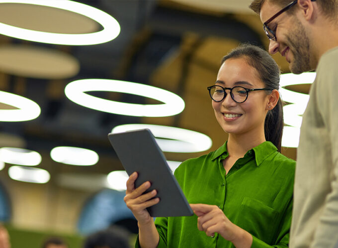 Man and woman talking with tablet