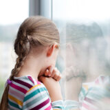 Child looking out a window