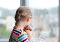 Child looking out a window