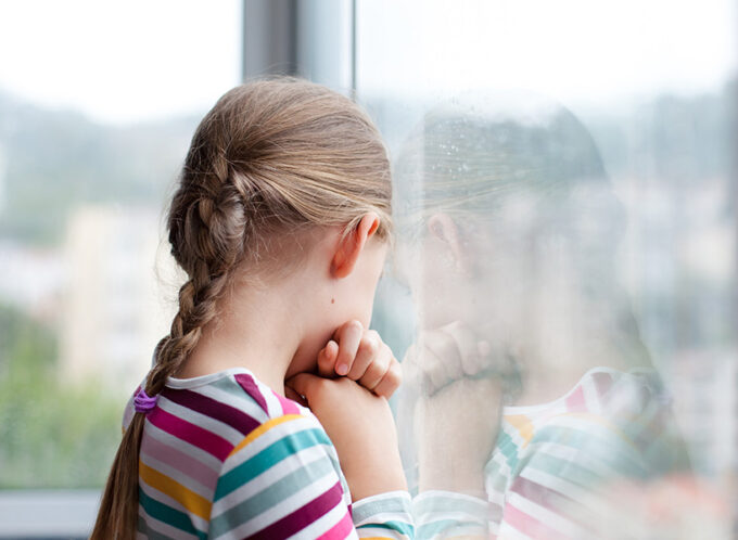 Child looking out a window