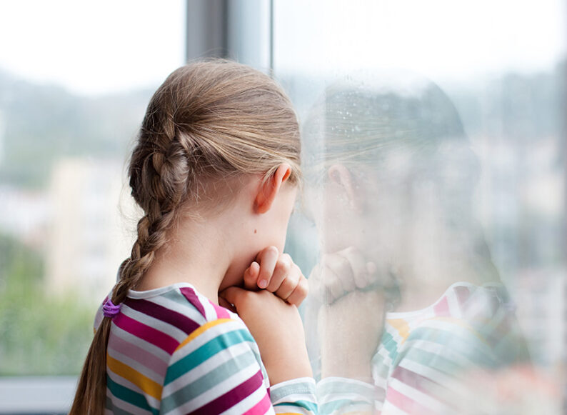 Child looking out a window